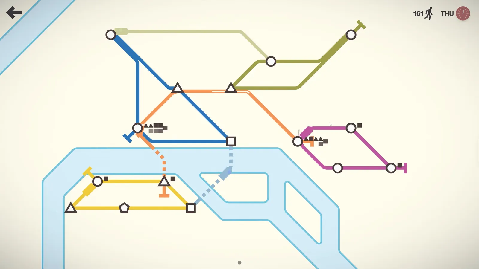 A Mini Metro map with colored subway lines crossing a river between circle, triangle and square stations