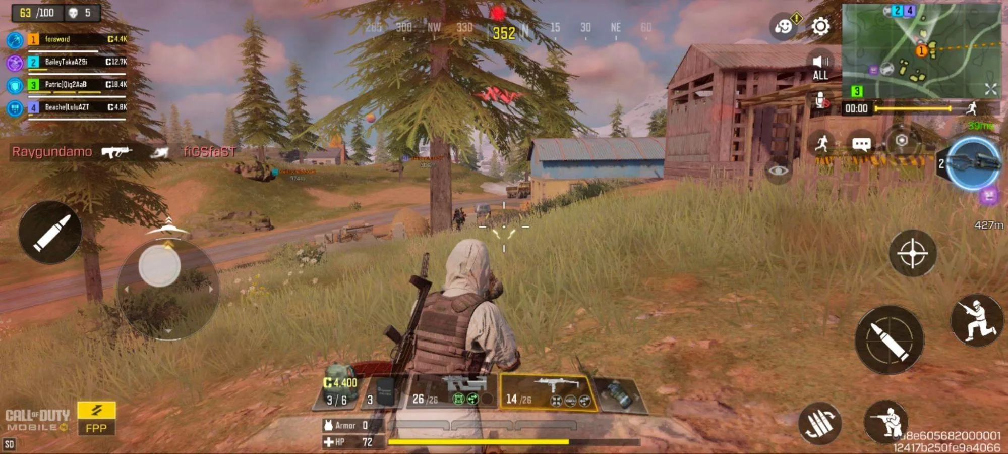 A Call of Duty Mobile battle royale match with 63 players remaining, the player crouched in tall grass near a barn