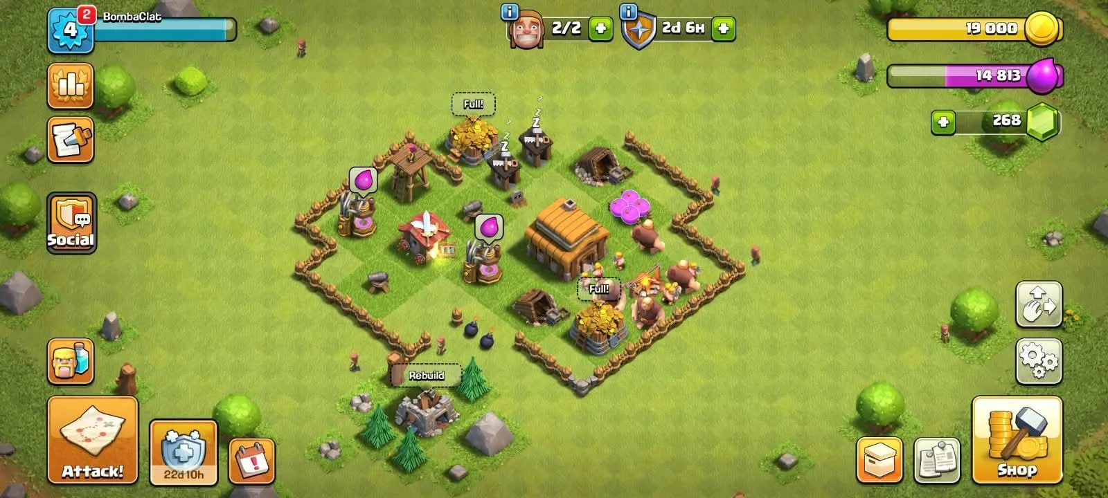 An early Clash of Clans village inside its walls, with the Town Hall in the centre and the Attack, Shop and Clan buttons around the edges