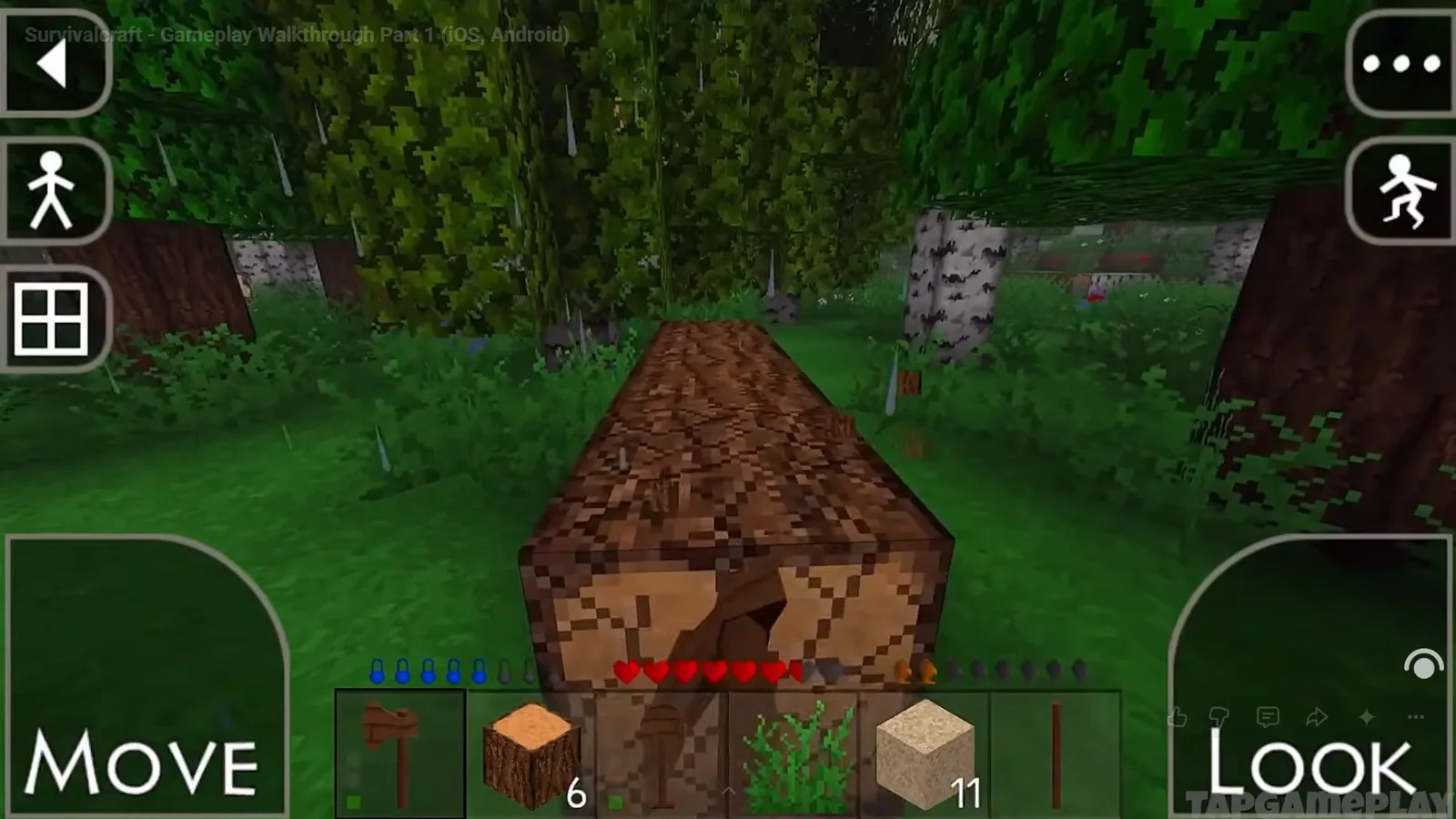 A Survivalcraft forest seen through the mobile touch controls, with a felled log and a hotbar of wood, sand and tools